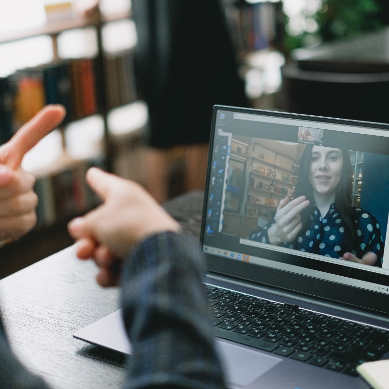 Video conference with people using sign language to communicate through their web cameras.